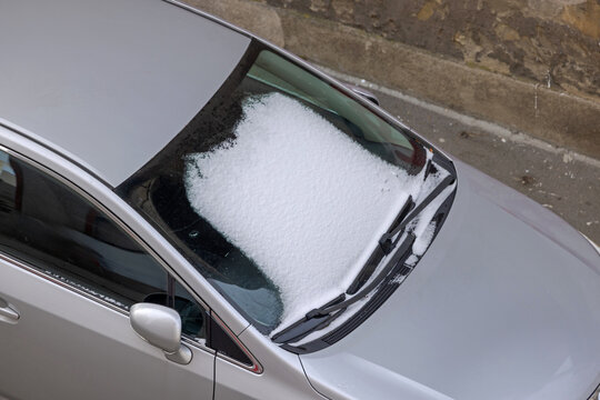 Aerial View of Car Windscreen Covered With Fresh Snow Winter Weather Transport Problems