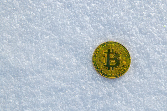 Gold Coin with B Symbol on Snow Surface