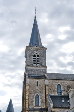 France, Valras Plage August 08, 2026 &mdash; Handheld stabilized shot of the historic stone bell tower and spire of Eglise Notre-Dame de Matignon with smooth camera motion and professional color graded fini