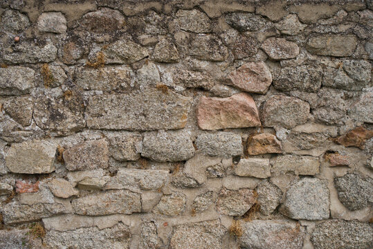 France, Valras Plage August 08, 2026 &mdash; Stock photograph of an old ancient stone wall texture background with rustic medieval masonry blocks and rough weathered rock surface structure
