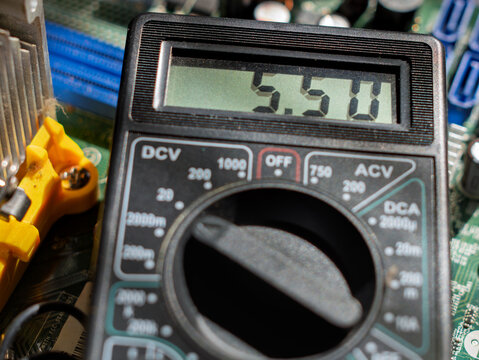 Digital Multimeter Displaying Voltage Reading on Circuit Board