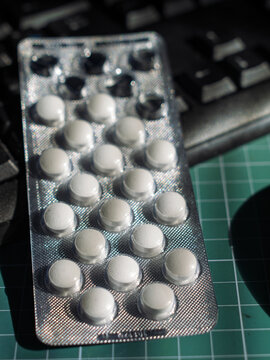 Medical Blister Pack with White Tablets on Keyboard