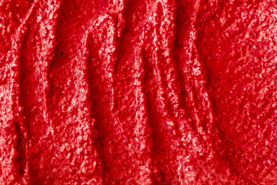Red berry yogurt ice cream. Fresh fruit smoothie with strawberries, raspberries, pomegranate and red currants. Ice cream texture. Delicious sweet dessert close-up as a background.