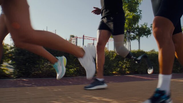 Mixed fitness group runs together along sunny park pathway