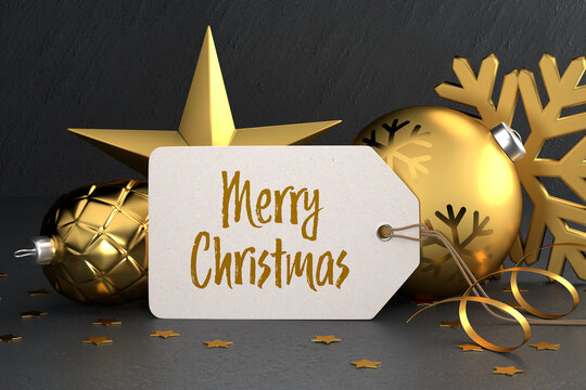 Christmas - Gift Tag with the message "Merry Christmas" on a black stone background leaning against gold colored christmas ornaments