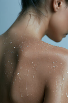 Water droplets on wet neck and shoulder skin dim light macro