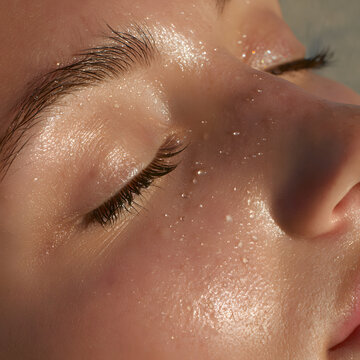 Dew Drops Glistening on Face Skin Close Up