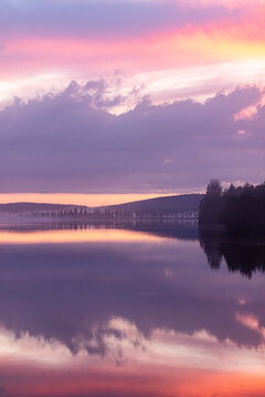Pink Sunset Clouds Mirrored in a Peaceful Northern Lake