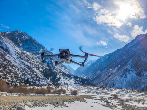 Drone Flying Over Snow-Covered Mountain Valley
