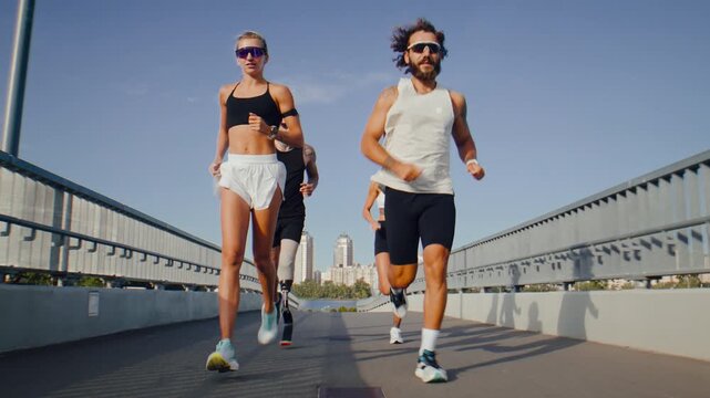 Group of runners approaches end of bridge during sunny workout