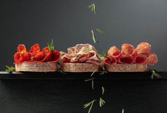 Sandwich with thin slices of Italian dry cured prosciutto, salami, and chorizo sausages.