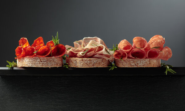 Sandwich with thin slices of Italian dry cured prosciutto, salami, and chorizo sausages.