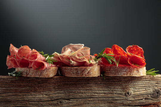 Sandwich with thin slices of Italian dry cured prosciutto, salami, and chorizo sausages.