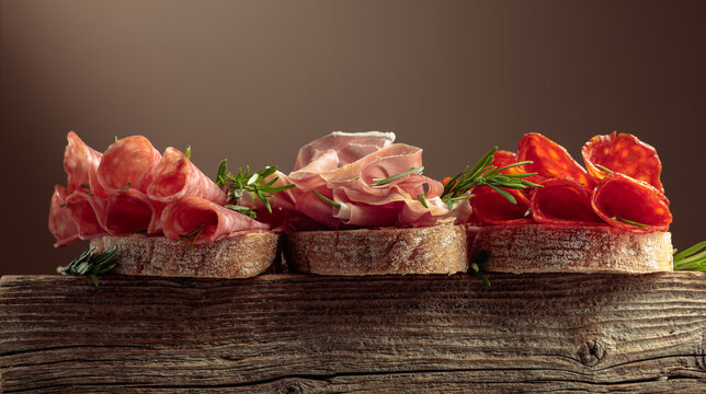 Sandwich with thin slices of Italian dry cured prosciutto, salami, and chorizo sausages.