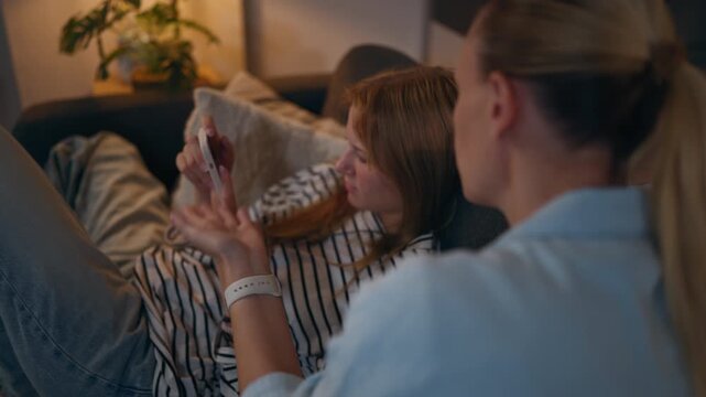 Teenage girl ignoring concerned mother while scrolling social media on smartphone, representing phone addiction, excessive screen time, digital distraction, family tension and parenting challenges