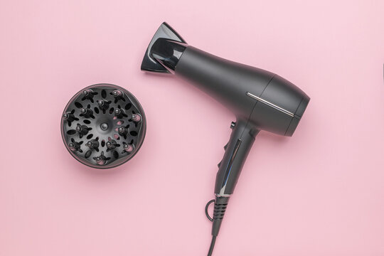 Modern Black Hair Dryer with Diffuser on Pink Background for Stylish Blowouts