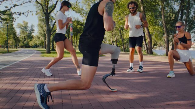 Athletes practice deep lunges together during outdoor warmup