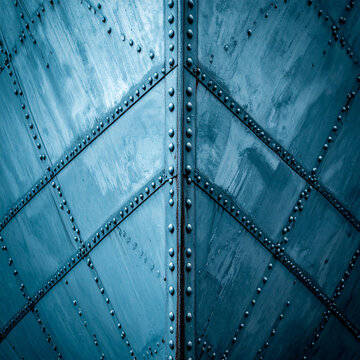 Blue metal panel with diagonal beams and rivets industrial nautical texture
