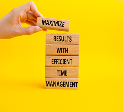  Concept words maximize results with efficient time management on wooden blocks. Businessman hand. Beautiful yellow background. Business concept. Copy space.