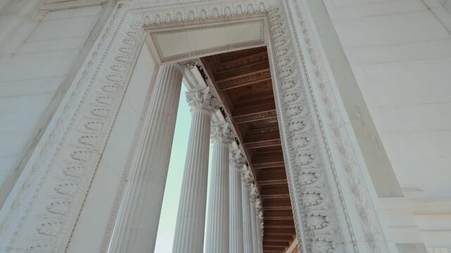 Low angle architectural view of Corinthian marble columns at Altare della Patria against blue sky