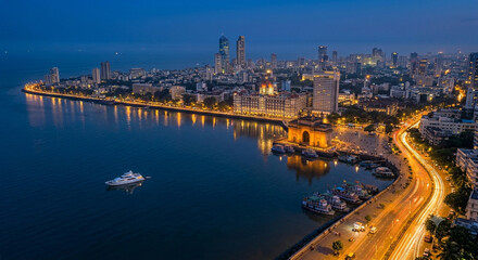 Fototapeta premium Panoramic Mumbai Skyline at Blue Hour with Illuminated Skyscrapers, Arabian Sea Horizon, Vibrant Evening Sky and Financial Capital Cityscape Maharashtra India