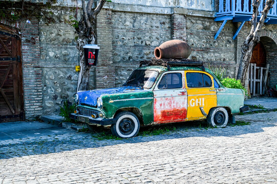 A colorfully painted Moskvich-407 car from the 1950s and 1960s with a kvevri clay jug on the roof rack and the inscription &ldquo;Sighnaghi,&rdquo; Kakheti, Sighnaghi, Georgia 12.04.2025