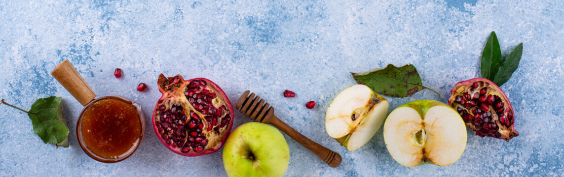 Rosh Hashana Jewish New Year concept with honey apple and pomegranate