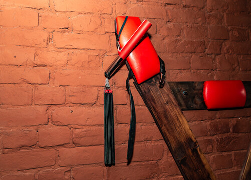 SM cross or Andreaskreuz is used in the BDSM scene on red background