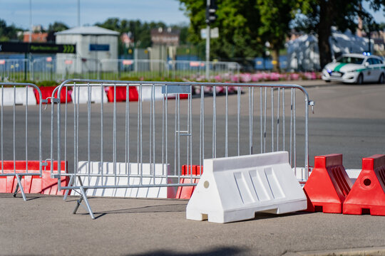 Modular steel crowd control barricades and plastic safety barriers erected for pedestrian management, street routing, and event perimeter setup