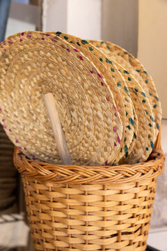 hand woven fans artisanal in a basket for sale in boutique in portugal
