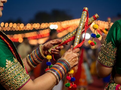 Woman holding dandiya sticks for garba dance during navratri festival
