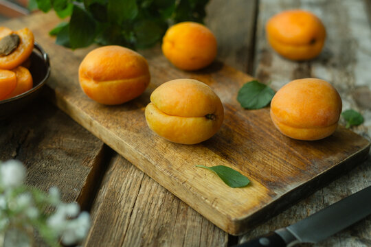 Fresh ripe apricots on wooden background 