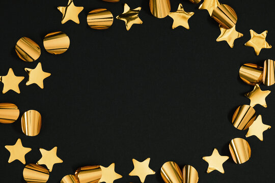 Festive Frame of Golden Star and Round Confetti on Black Background. Elegant Flat Lay Layout with Central Copy Space for New Year, Christmas, Birthday, Wedding Invitation or Holiday Banner