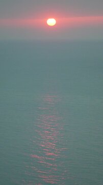 Sunset Ocean Horizon sun reflecting on calm sea water surface during a peaceful dawn or dusk
