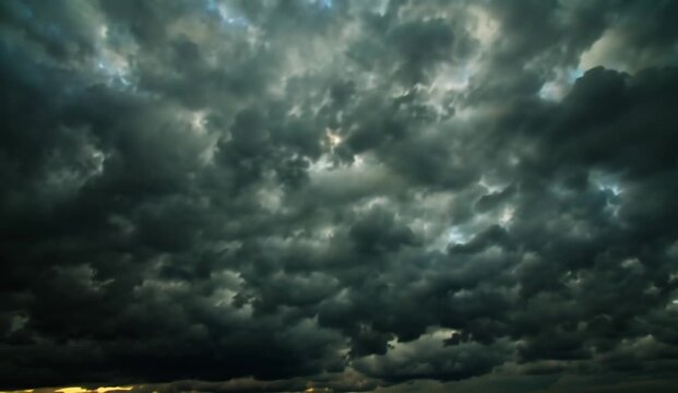 Dramatic panoramic cinematic cloudscape showing enormous dark rolling storm clouds after rainfall during the evening