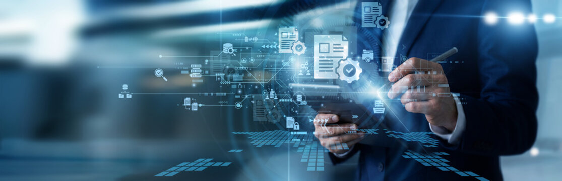 Office manager working on tablet updating document management systems, organizing secure corporate archives, classifying digital file directories, and tracking workflow version histories.