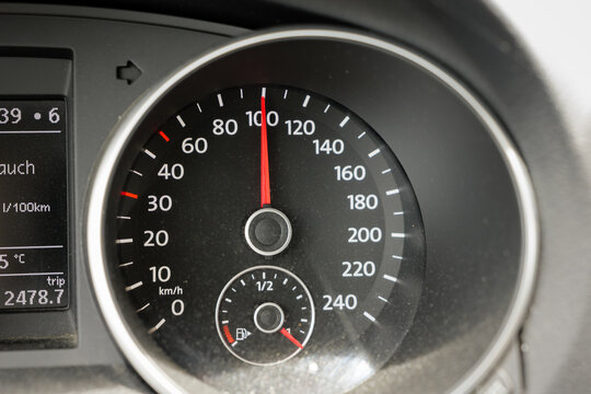 Speedometer in car at 100 km per hour. Close-up of tachometer when driving fast in Germany. Gauge in dashboard displaying the travel speed.