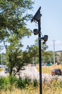 Solar powered automatic license plate reader camera installed on a suburban street pole for traffic monitoring near Georgetown Texas