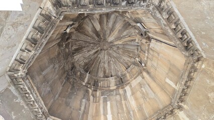 Athens, Greece - 8 July 2026. Upward view inside the Horologion of Andronikos Cyrrhestes, with an octagonal cornice surrounding the radial stone roof and central boss. © Michael