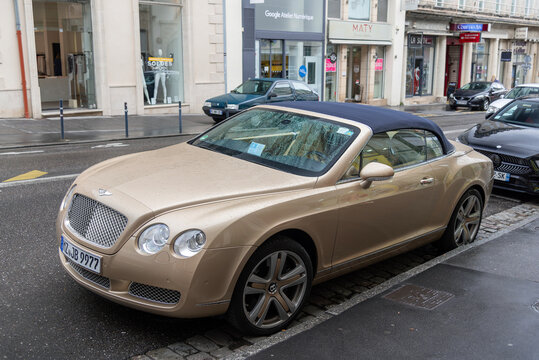 Nancy, France - July 27th 2019 : View on a beige Bentley Continental GTC parked on a street.