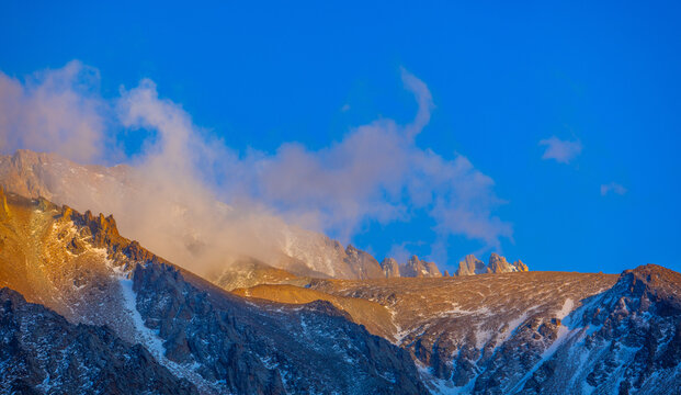 Golden Sunlight on Snowy Mountain Peaks in Kyrgyzstan