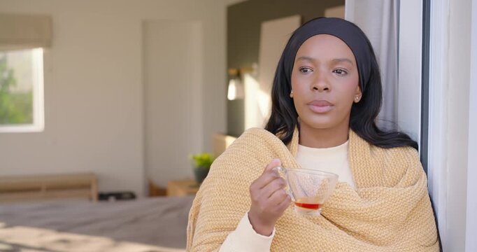 African American woman leaning at home door in mustard shawl holding cup seeing offscreen laughing