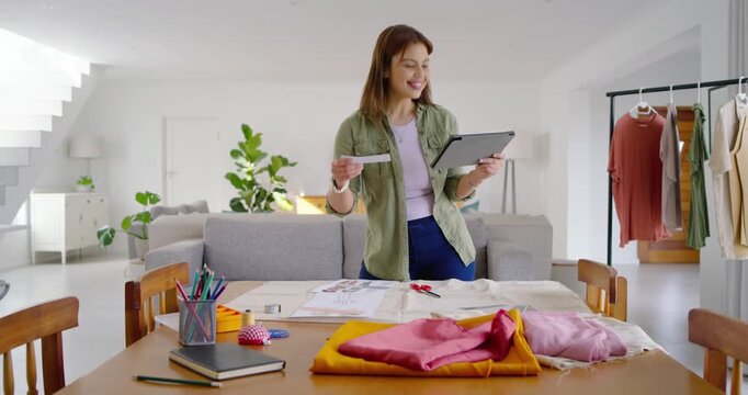 Consulting tablet, African American woman scrolling and picking pattern for sewing at home studio