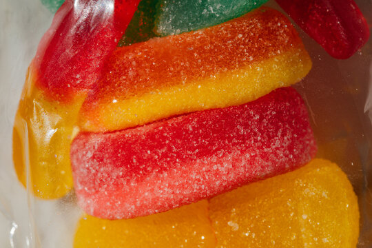 close up of sugary colorful gummy candy in plastic