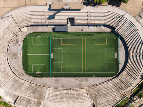 Aerial view of Tasmajdan Stadium featuring a green artificial turf soccer field surrounded by concrete seating tiers in Beograd, Grad Beograd, Serbia.