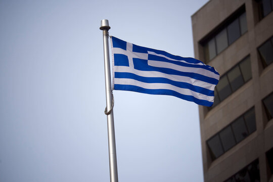 The Greek flag on a flag pole at Toronto City Hall&rsquo;s Nathan Phillips Square.

