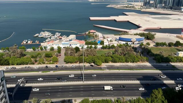 High angle view of highway traffic along the waterfront marina in Manama, Bahrain.