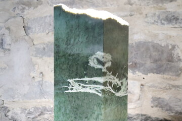 Piece of nephrite jade from Quebec. Green stone background and jade. Raw and polished jade. Geology science and mineral from Quebec. © Martine