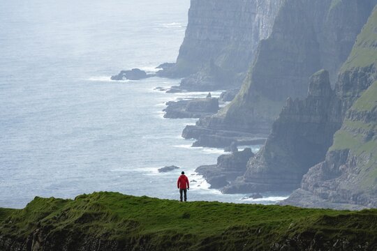 A person standing in the distance off the Beinisforo coast, V&aacute;gur, Suduroy, Faro Islands