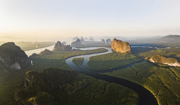 Aerial view, mangrove forest with meandering river and high karst rocks during sunrise, Ao Phang-Nga National Park, Phang-Nga Province, Thailand